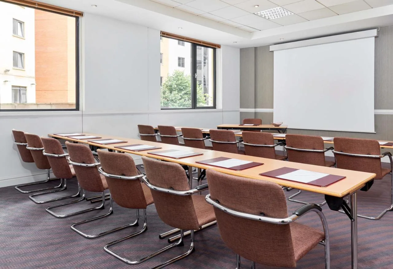 a conference room with a long table and chairs at Leonardo Hotel Newcastle in Newcastle upon Tyne